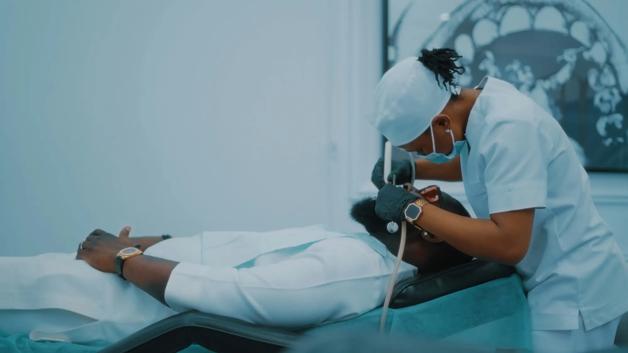 Clinical staff in scrubs at work in a treatment room
