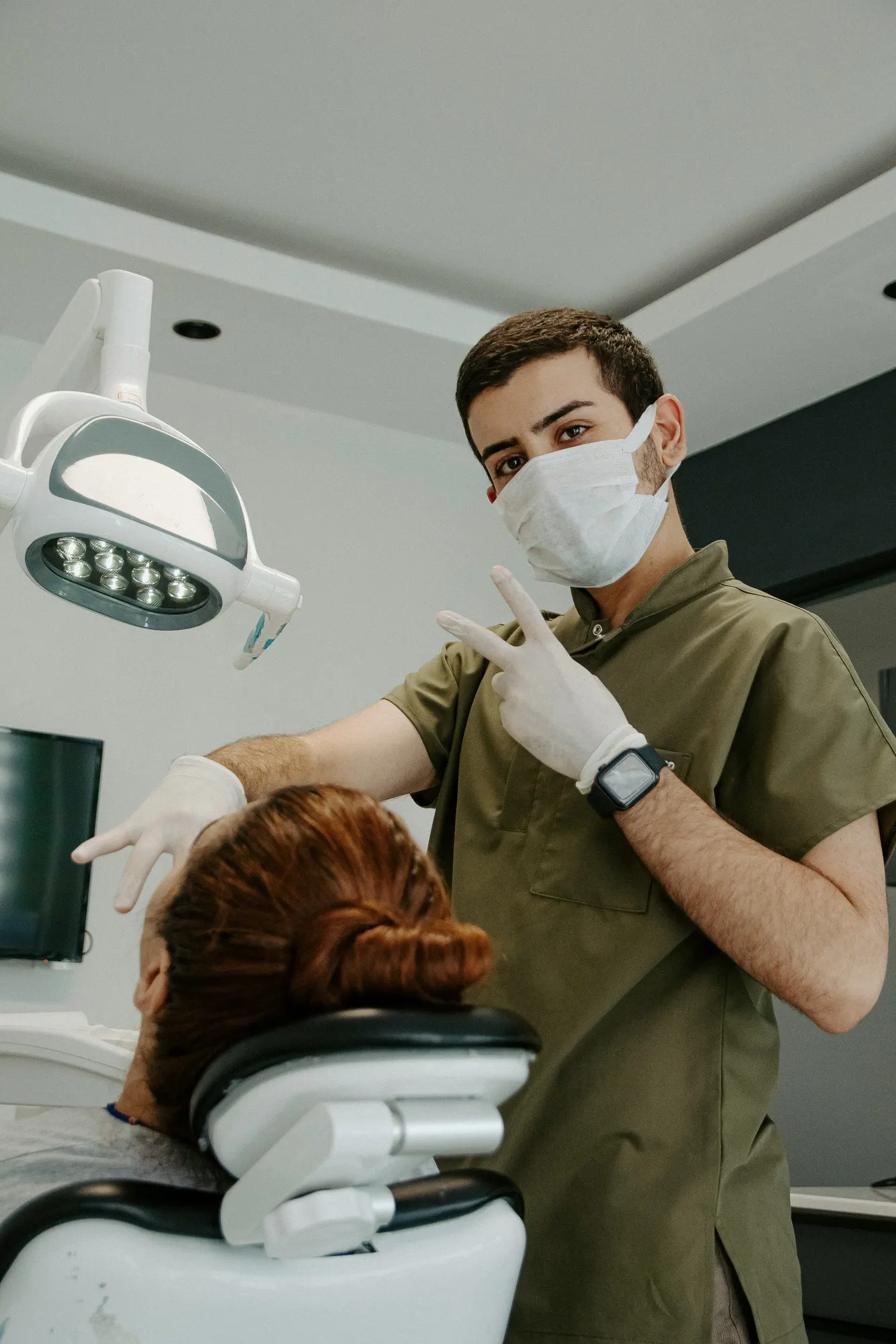 A clinician in scrubs in a treatment room