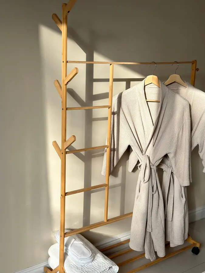 A spa therapist in uniform in a treatment room